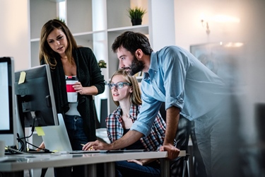 Business people around computer